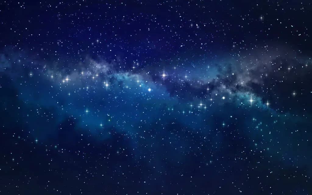 A deep blue night sky filled with stars and the glowing band of the Milky Way