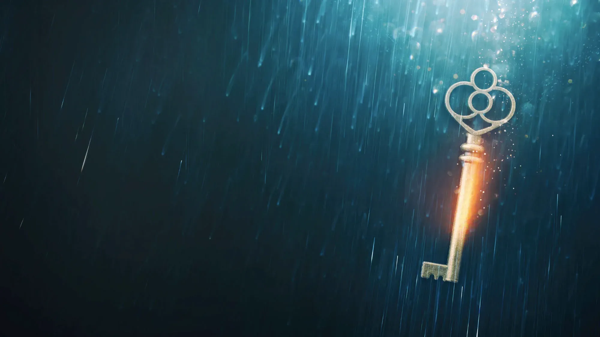 An old brass key hanging in a shaft of light with rain falling around it