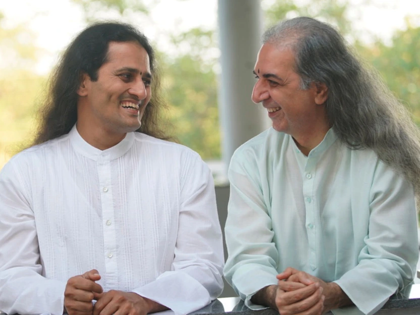 Bawa and Dinesh mid-conversation, laughing