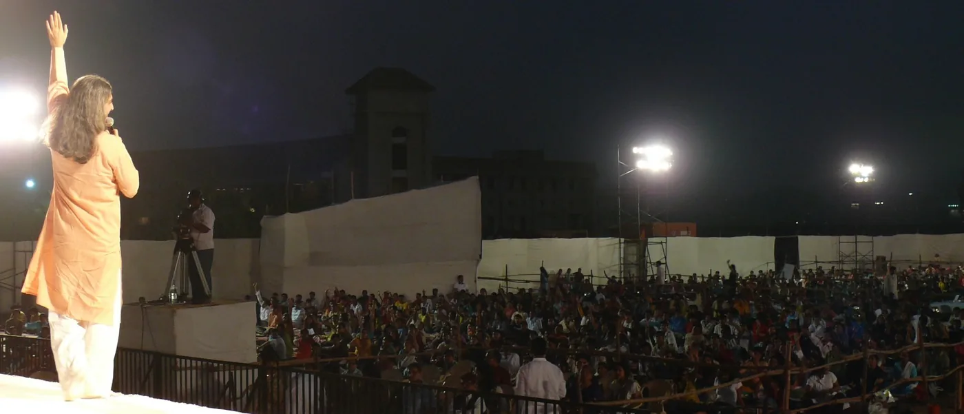 Bawa on stage before a large night-time crowd in Mumbai