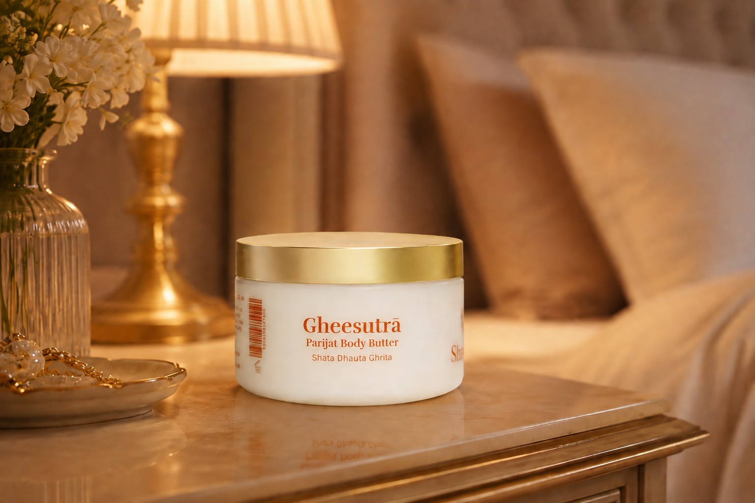 A jar of parijat body butter, open, beside white flowers